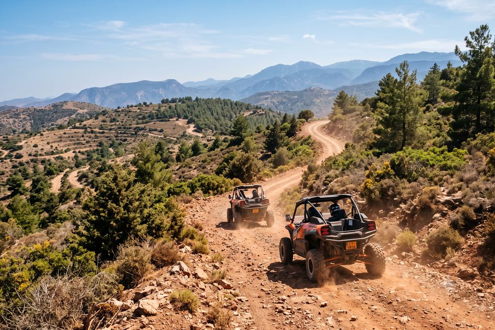 Two off-road buggies climbing a dirt mountain track through Cypriot hills